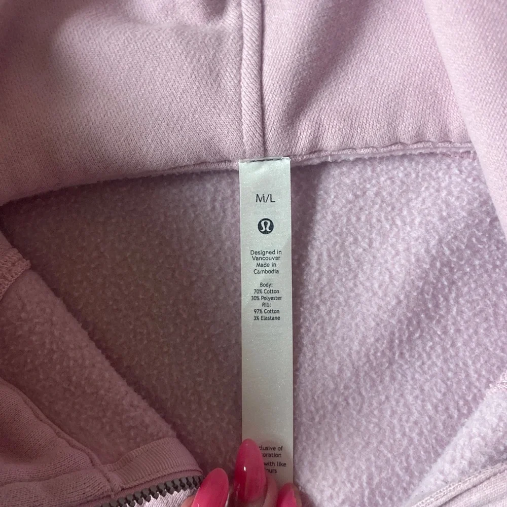 Women's jacket tag inside a pink hoodie